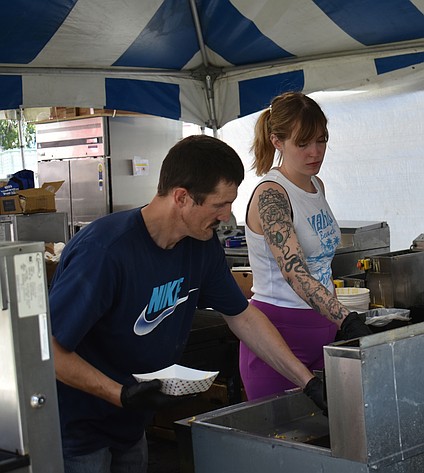 Albert Otterson, left, and Kylie Mathews work the deep fryers ahead of the hungry crowds at Spring Fest Thursday.