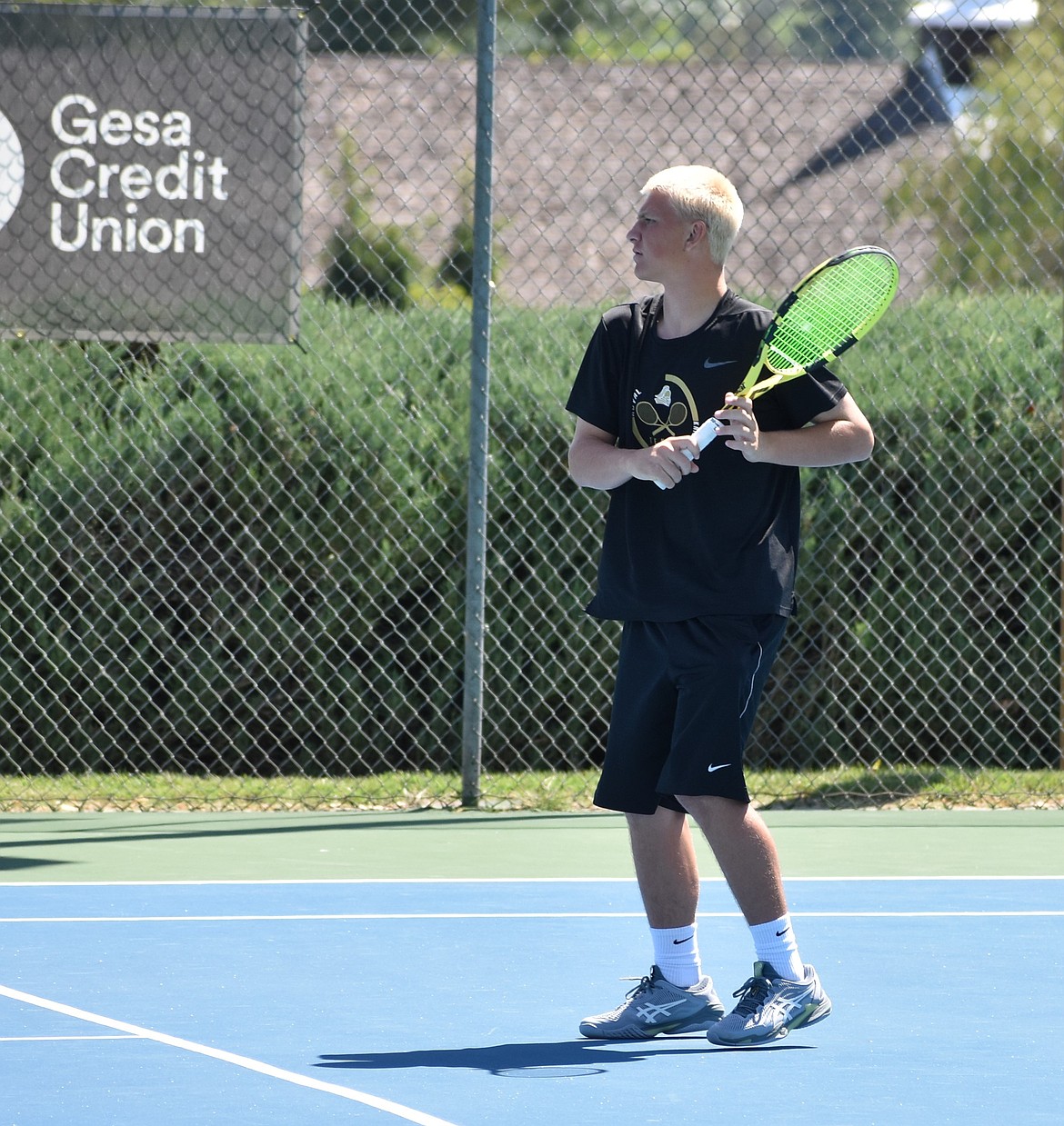 Knights player Cael Orth warms up for his match against Austin Peas from Cascade Christian during the 1A State Tennis tournament.