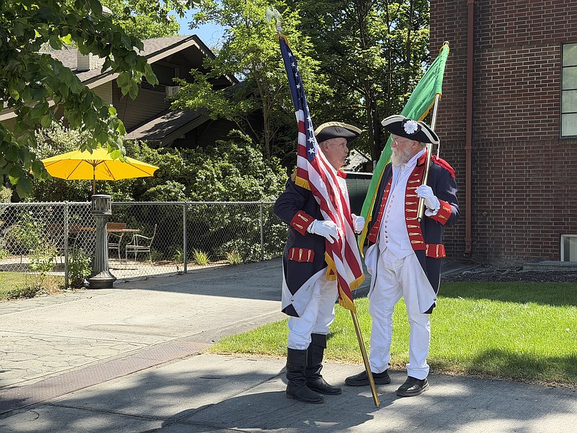 Two members of the Spokane Chapter #1 of the Sons of American Revolution wait to do the flag presentation Friday at the Nat Washington House. Historical organizations across the state made their way to Ephrata to celebrate the house for Historic Preservation Month.