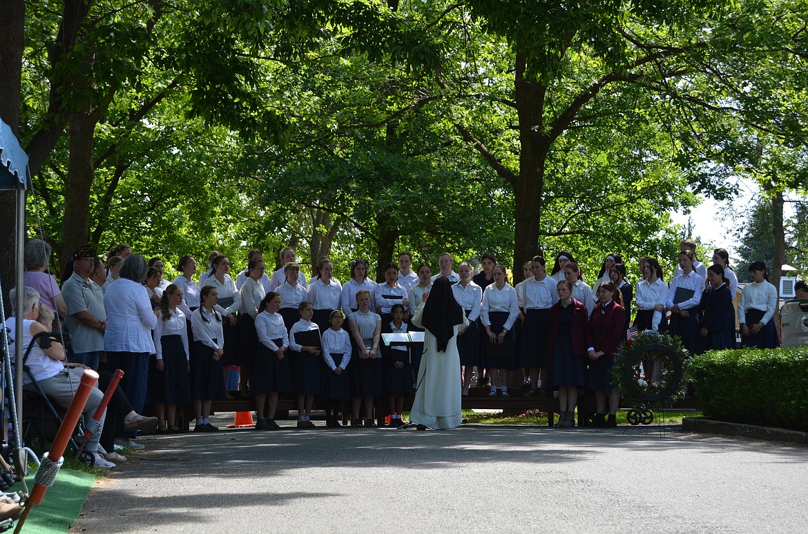Members of the St. Dominic’s Girl’s School choir raise their voices for the hundreds gathered Monday to celebrate Memorial Day in Evergreen Cemetery in Post Falls.