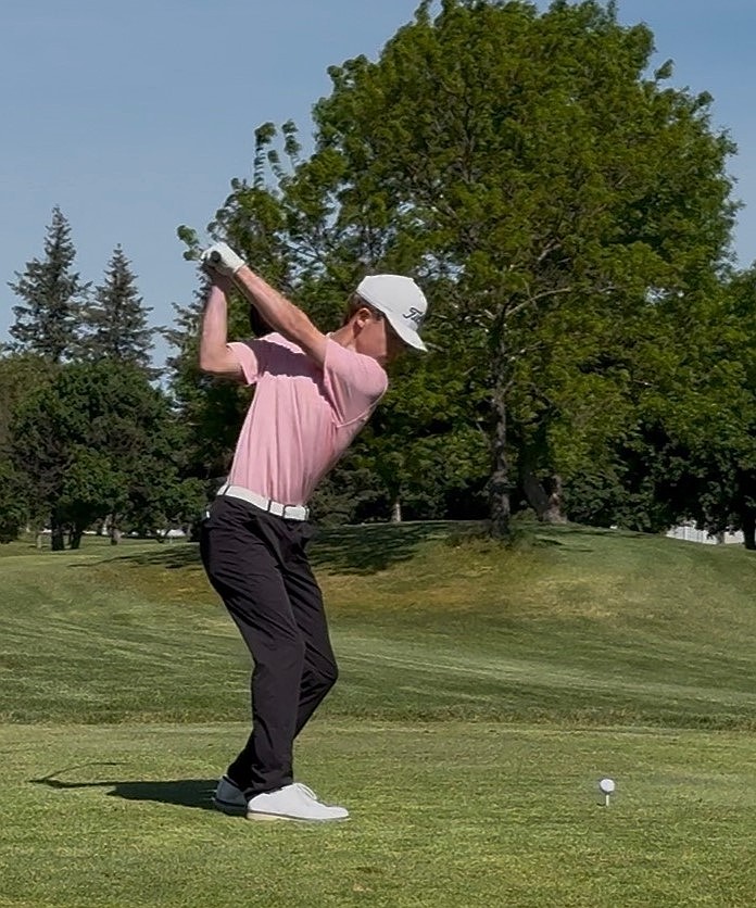 Everett Cox, a sophomore from Warden, steps onto the course to hit the ball during the state meet.