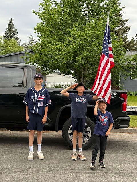 Courtesy photo  
The Everson brothers, from left, Kyle, Hunter and Brendan, pose with a flag on Monday. Members of the Coeur d'Alene Lumbermen American Legion baseball program’s class AA team spent Memorial Day placing roughly 300 flags at residences in the community in the morning, then members of the 16U team collected them that night. The flag project is a partnership with the Lumbermen and the Kiwanis club. It honors the nation by displaying flags in neighborhoods in Coeur d'Alene, and helps develop a service attitude in the players.