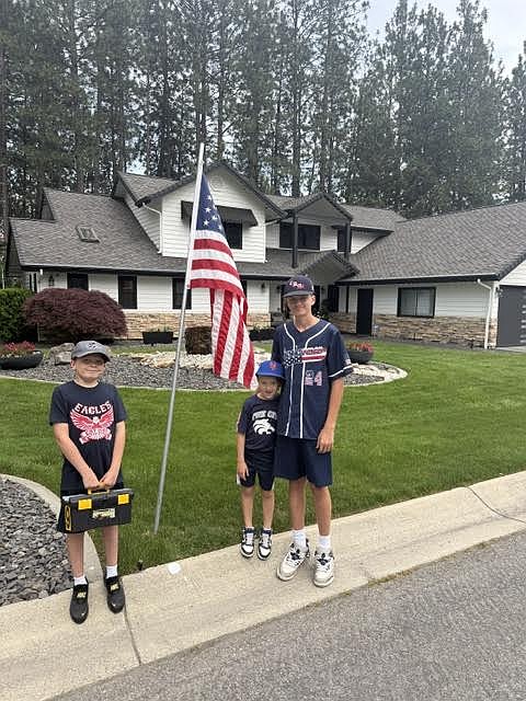 Courtesy photo  
From left, brothers Mason, Camden and Blake Anderson pose with a flag on Monday. Members of the Coeur d'Alene Lumbermen American Legion baseball program’s class AA team spent Memorial Day placing roughly 300 flags at residences in the community in the morning, then members of the 16U team collected them that night. The flag project is a partnership with the Lumbermen and the Kiwanis club. It honors the nation by displaying flags in neighborhoods in Coeur d'Alene, and helps develop a service attitude in the players.
