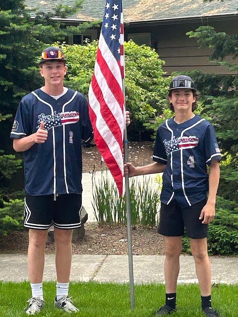 Courtesy photo  
Coeur d'Alene 16U players Trent Lilyquist, left, and Nash Russell pose with a flag on Monday. Members of the Coeur d'Alene Lumbermen American Legion baseball program’s class AA team spent Memorial Day placing roughly 300 flags at residences in the community in the morning, then members of the 16U team collected them that night. The flag project is a partnership with the Lumbermen and the Kiwanis club. It honors the nation by displaying flags in neighborhoods in Coeur d'Alene, and helps develop a service attitude in the players.