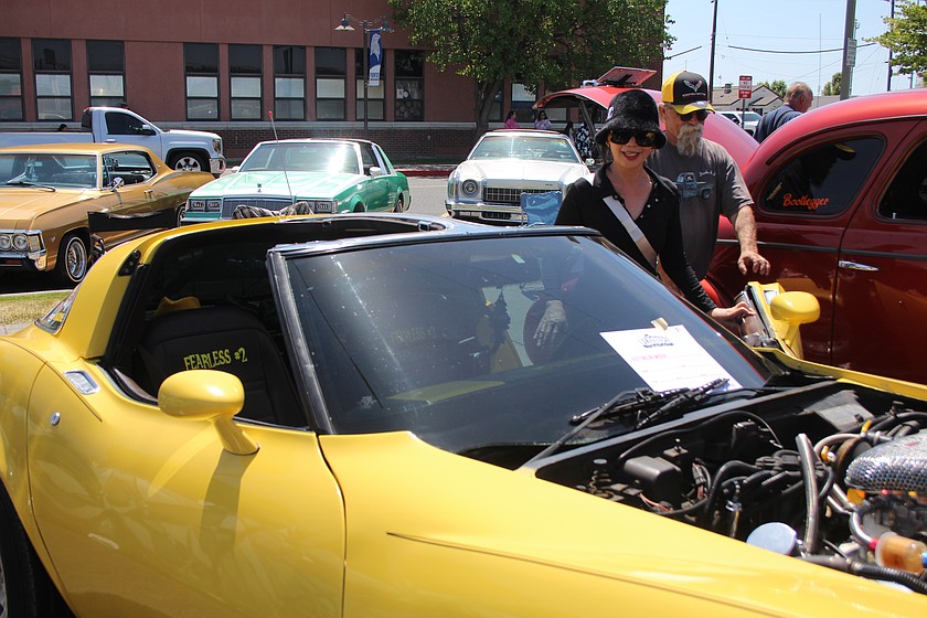 Owner Warren Strader opens the door of his 1978 Corvette for a Spring Festival car show visitor.