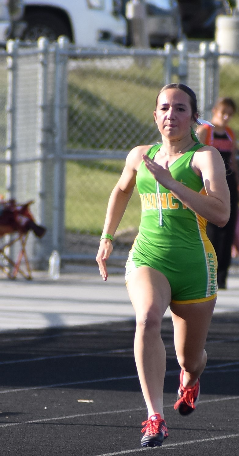 Quincy freshman Brielle Baughman sprints down the lane during the district meet last week.