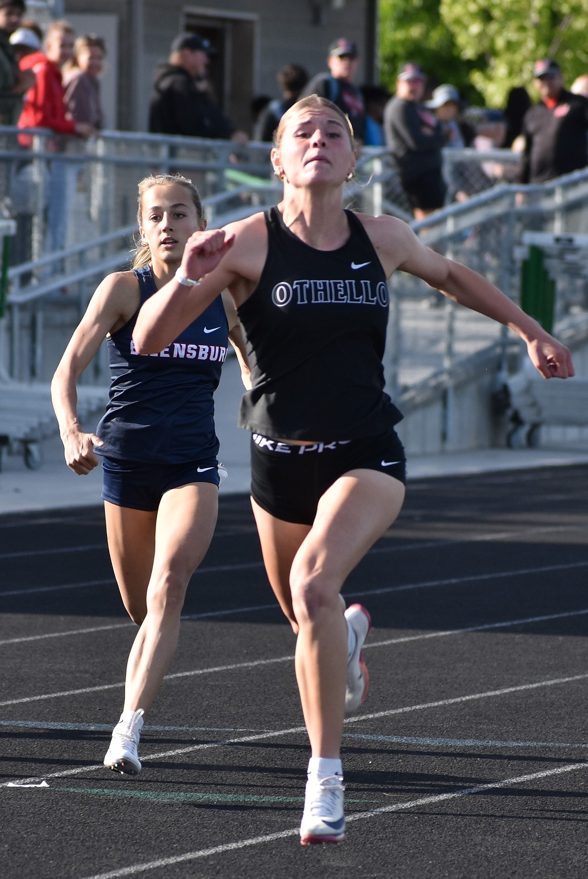 Abby Douglas a senior from the Huskies speeds down the lane to take first in the 200m event at districts.
