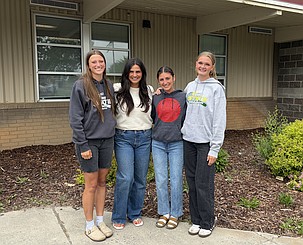 Faith Risenmay, Coach Priscilla Tovar, Olivia Harris and Shaylee Freeman stand together outside of Othello High School after reflecting on the successful tennis season.