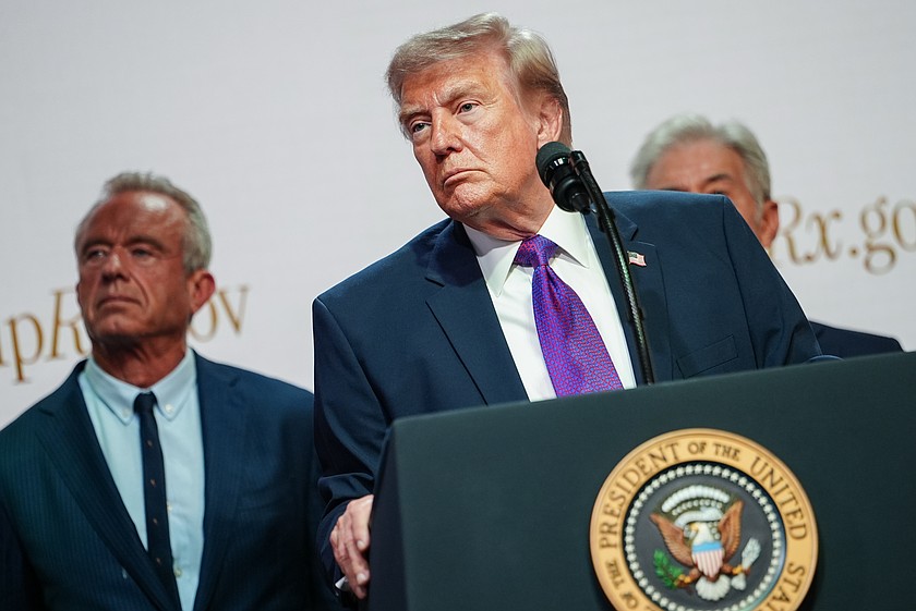 Health and Human Services Secretary Robert F. Kennedy Jr. and Centers for Medicare & Medicaid Services administrator Dr. Mehmet Oz watch as President Donald Trump speaks to reporters during an event on prescription drug prices in the South Court Auditorium of the Eisenhower Executive Office Building, Monday, May 18, 2026, on the White House campus in Washington. (AP Photo/Julia Demaree Nikhinson)