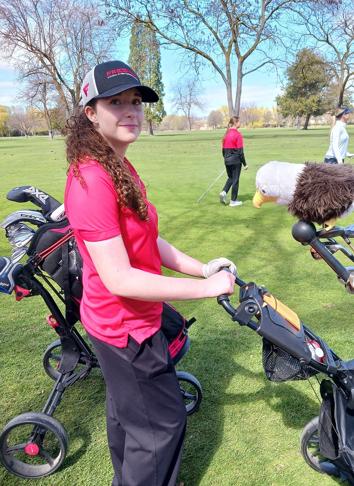 Khya Parrish stands by her golf bag during a prior tournament earlier this season. Parrish earned honorable mention honors on the Central Washington Athletic Conference 2026 All-League team.