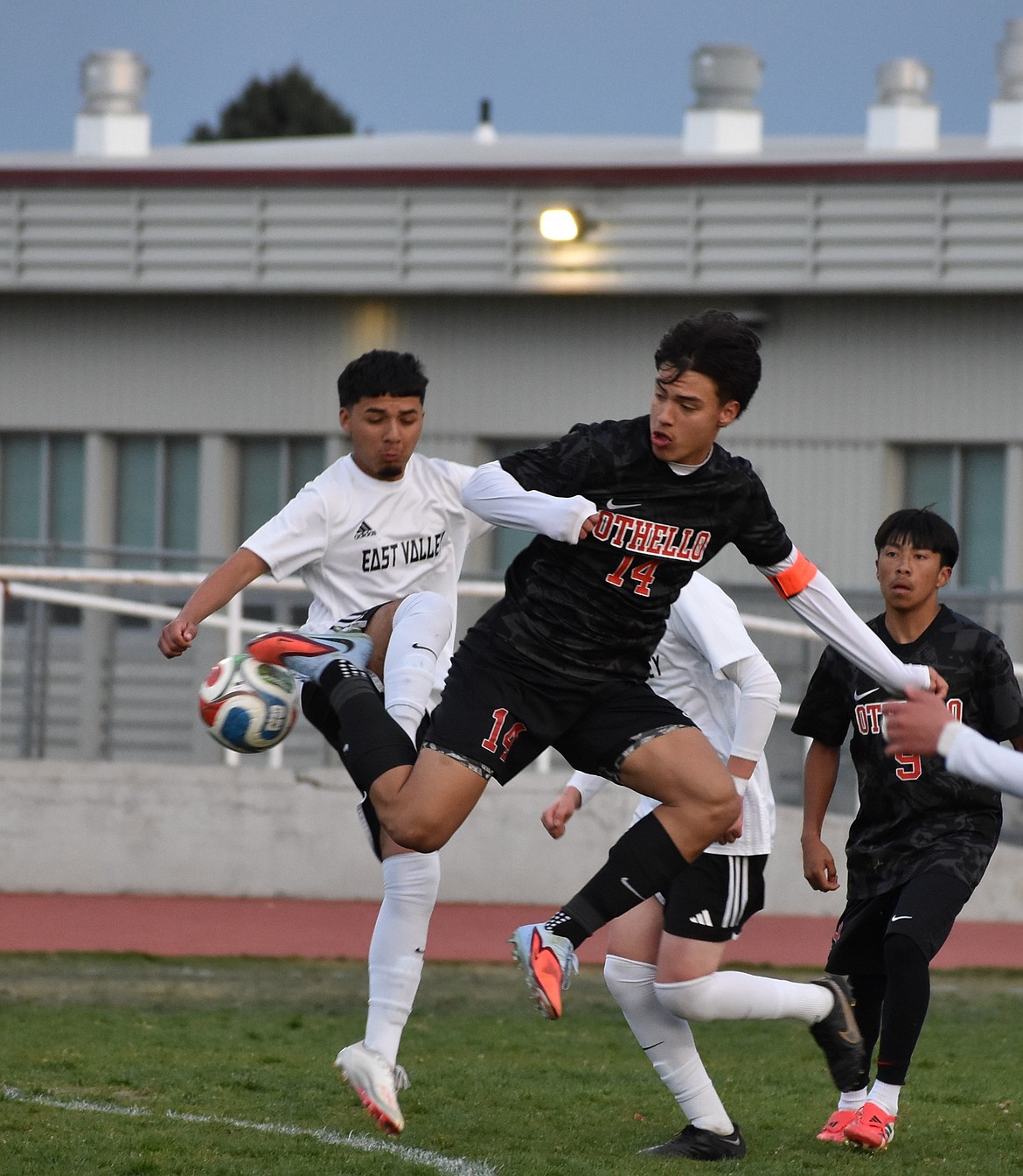 Huskies senior Luis Farias leaps in the air along with an East Valley player as they collide for possession of the ball earlier this season