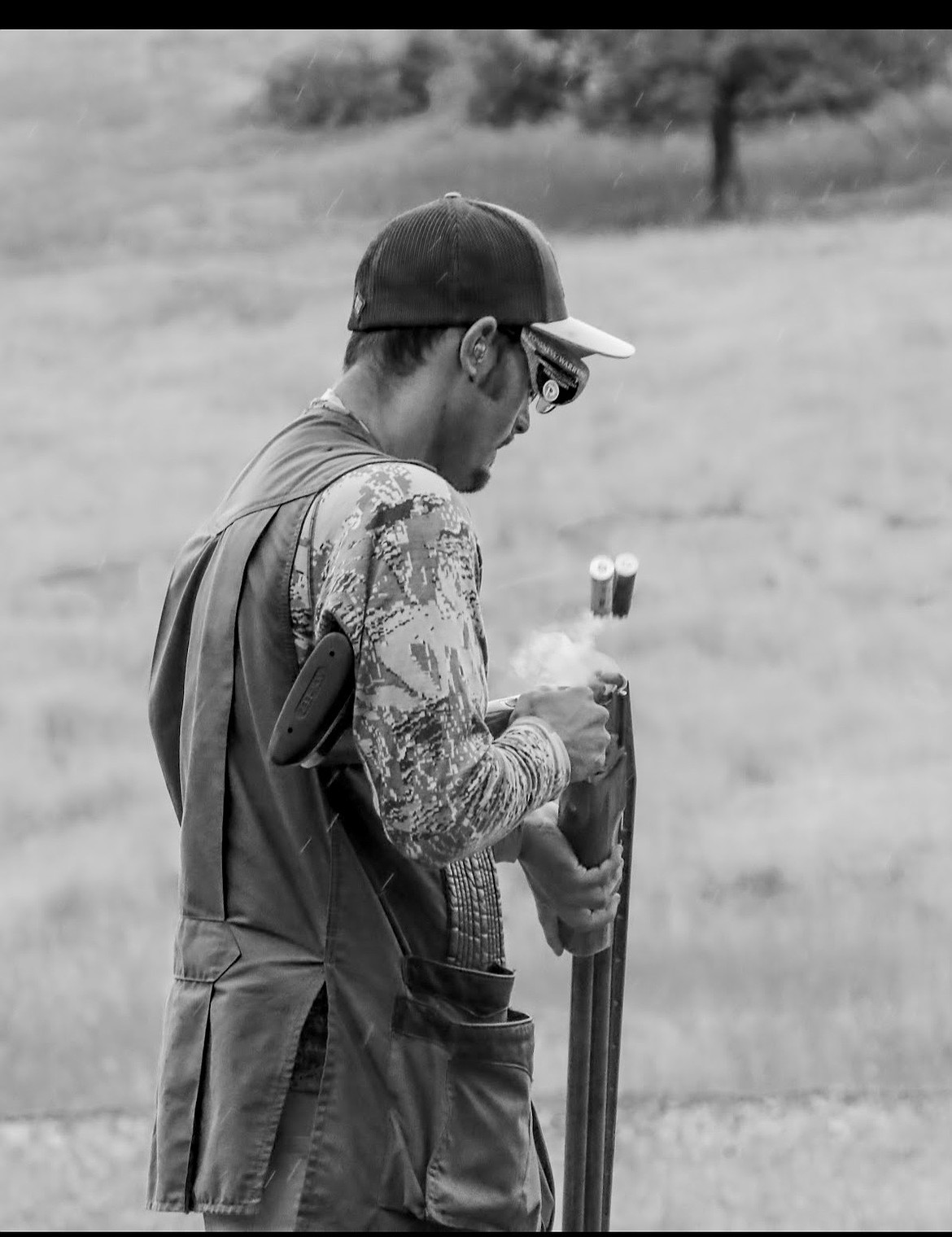 Grant Williams ejects spent shells after firing during a trapshooting round. Williams began competitive shooting at age 11 and rose to become one of the sport’s top competitors.