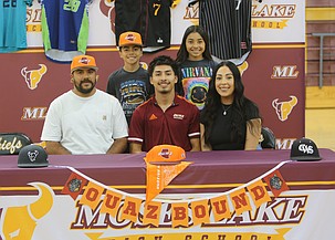 Noah Hernandez (maroon polo) sits surrounded by his family as he signs to play college baseball at Ottawa University Arizona.