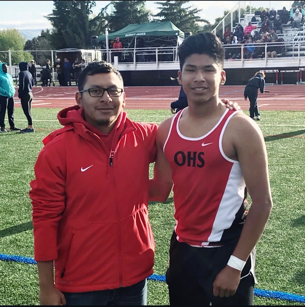 While a Huskie competitor, David Maldonado (right) and Aurelio Guevara (left) take a photo together at a race.