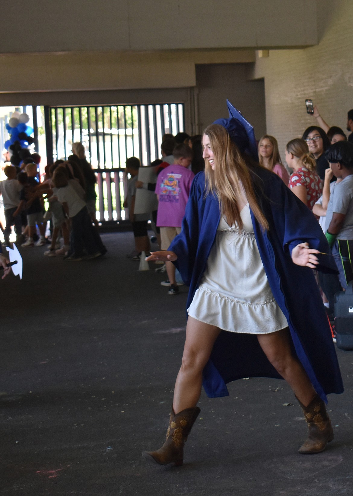 A Vanguard Academy senior responds to cheers at the Graduate Parade at Peninsula Elementary School Thursday.