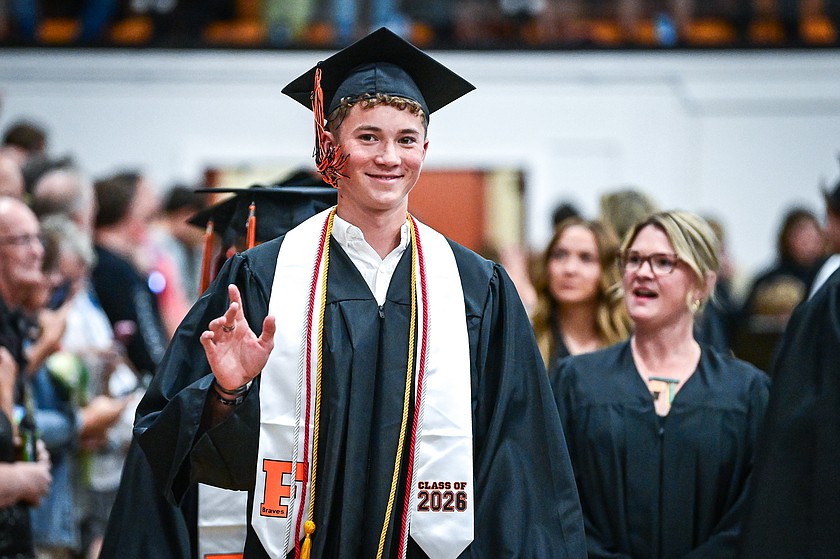 Nate Moy waves to the crowd as graduates file into the gymnasium for Flathead High School's class of 2026 graduation ceremony on Friday, June 5. (Casey Kreider/Daily Inter Lake)