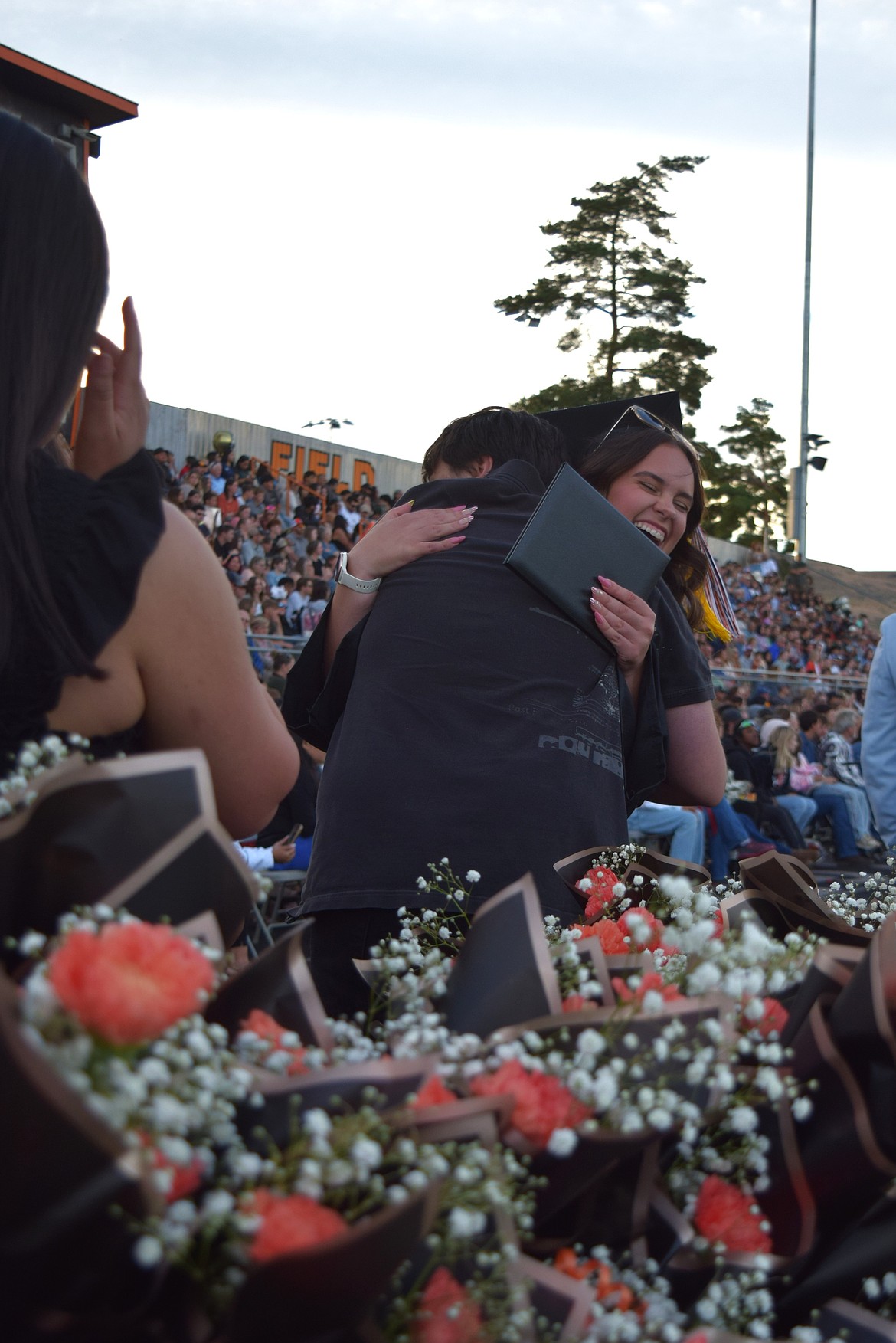 ASB President Cecilia Roth hugs one of her friends after getting her diploma Friday. Her speech focused on showing kindness to everyone, even those who don’t return the gesture.