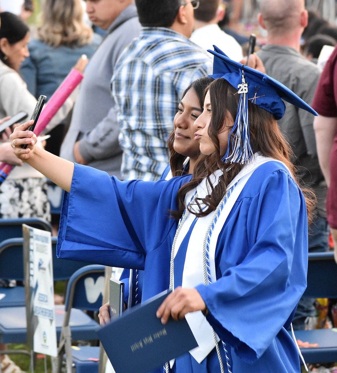 Two Warden graduates take a selfie as they exit the stage and prepare to join friends and family following the ceremony.