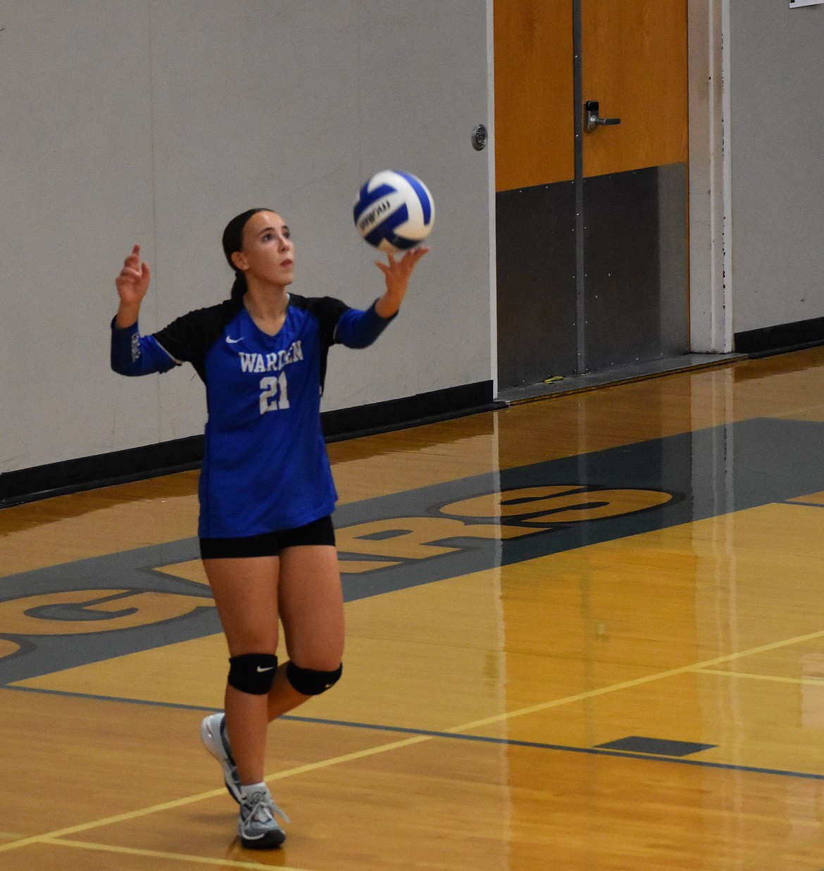 Warden’s Amaya Erickson prepares to serve during a home volleyball game in her senior season as a Cougar.