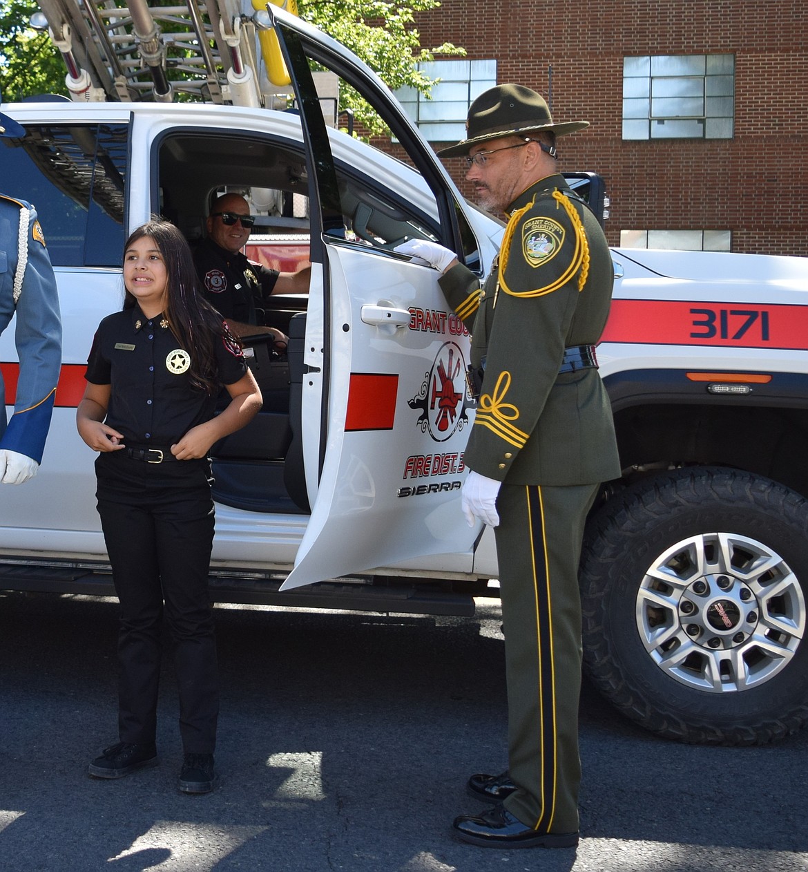 Grant County Fire District 3 Chief for a Day Rylie Gordillo is escorted out of the fire truck to the annual ceremony at the Grant County Courthouse.