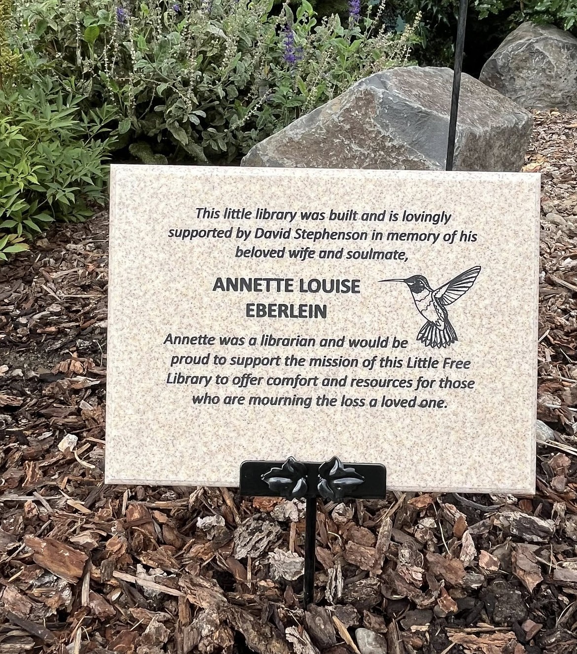 A plaque for Annette Eberlein shares the dedication of the little free library outside Hospice of North Idaho by her husband, David Stephenson.