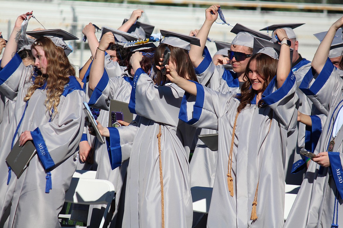 A graduate snaps a selfie as he turns her tassel during MLSD Digital Learning Center graduation Wednesday.