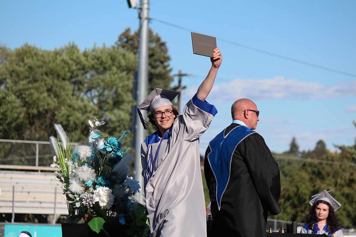 A graduate holds his diploma for everyone to see during MLSD Digital Learning Center graduation.