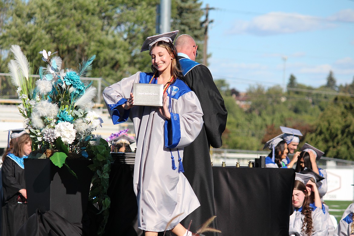 Having earned her diploma, a MLSD Digital Learning Center graduate shows it off.