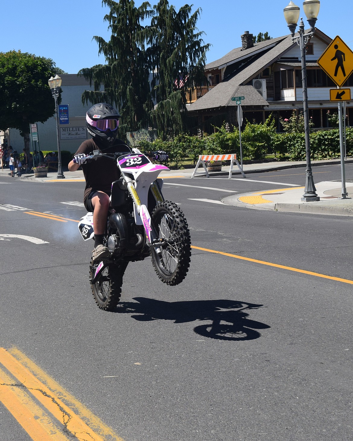 A dirt bike rider pops a wheelie during the parade Saturday.