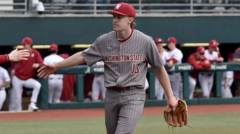 Nick Lewis from the WSU Cougars high fives one of his teammates during a game earlier this season. Lewis was named as a finalist for the ABCA Gold Glove award.