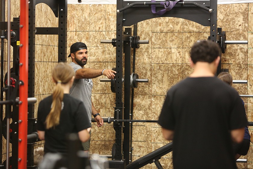 David Garza (in gray shirt) directs middle school athletes through a chin up workout. Garza’s private gym Athletic Breakthrough offers training programs for local Basin athletes.
