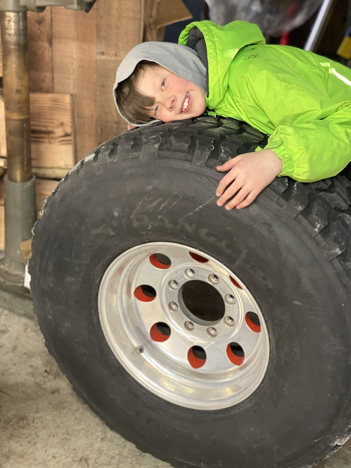 Brentley Ehmann poses with one of the tires in his dad's garage in Kalispell, Mont.