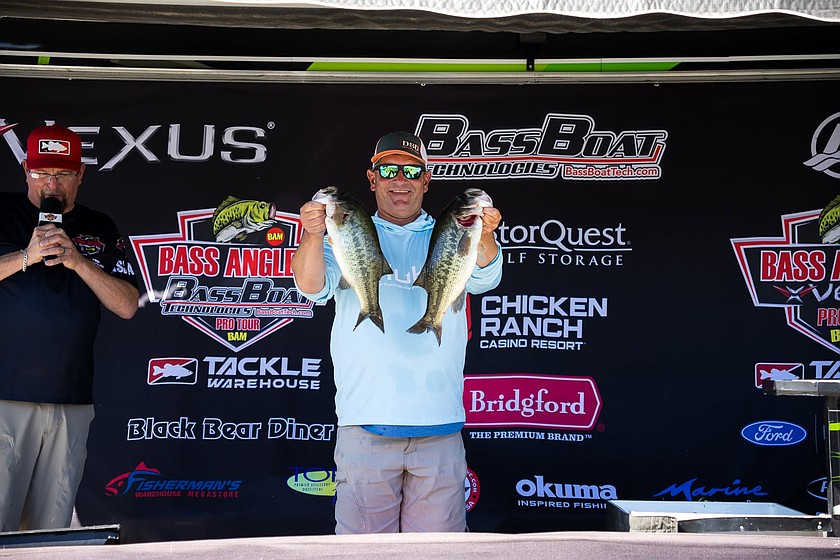 Moses Lake Pro-angler Aaron Ecthernkamp holds up two of his top catches from the weekend at the Potholes Reservoir. Ecthernkamp won the Pro-Am tournament with a total weight of 55.86.