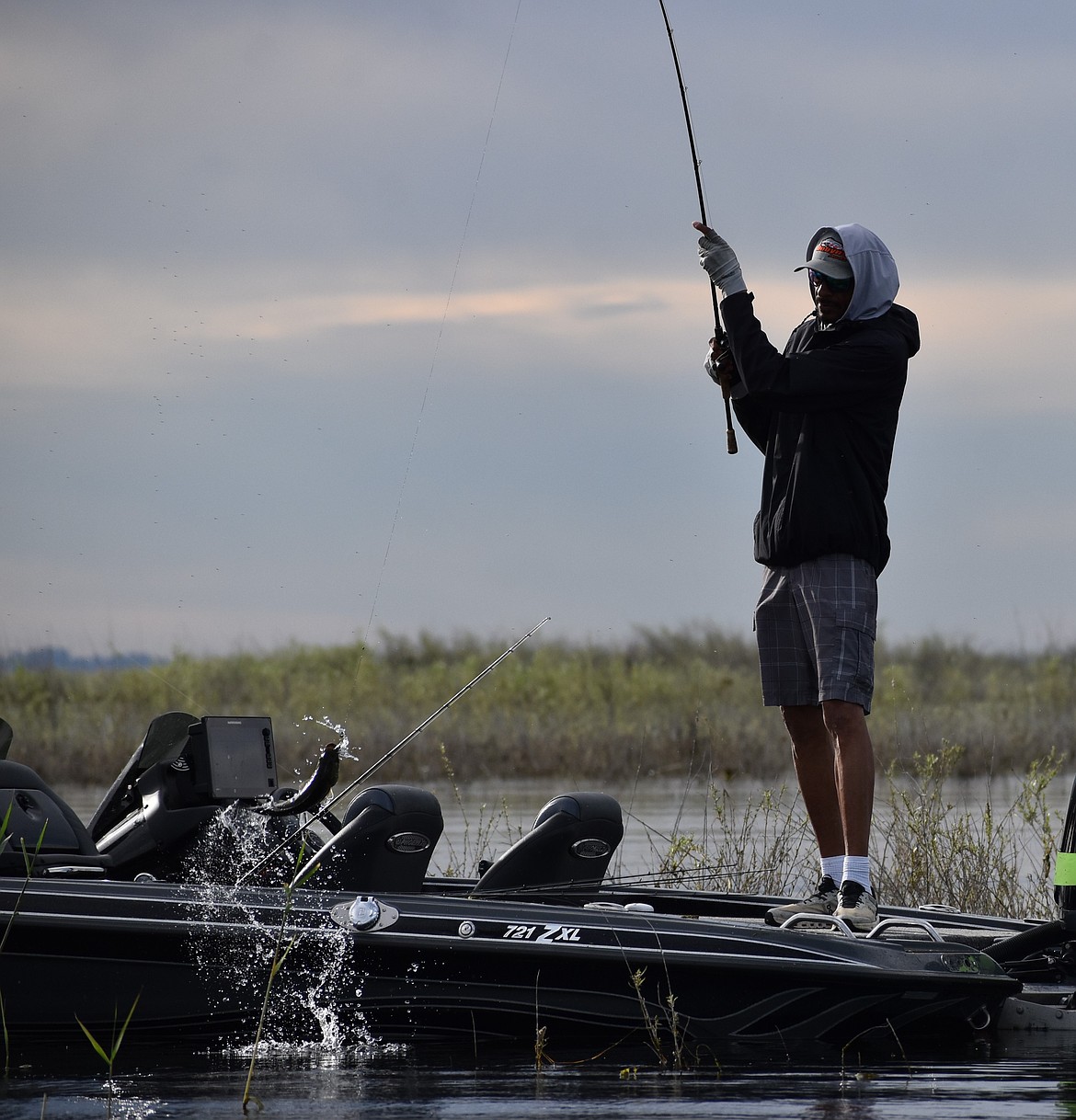 One of the competitors in the Pro-Am tourney pulls a largemouth bass out of the water during the first day of competition.