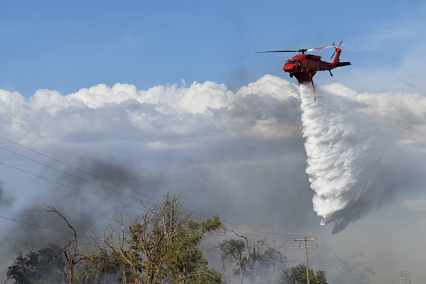 A helicopter drops retardant on a fire along I-90 east of Moses Lake Wednesday. The Schrag Fire had grown to 120 acres by 6 p.m. Wednesday. The fire is now contained.