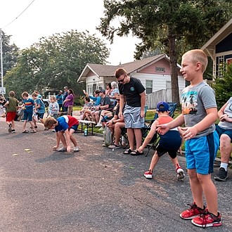 Children and their families line the street as they await the grand parade during a previous Benton Franklin Fair week.