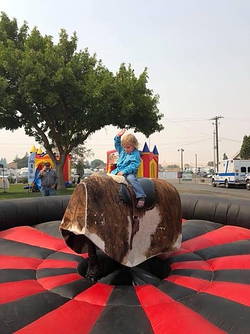 A very small bull rider shows off her form during the 2025 NCW Fair.
