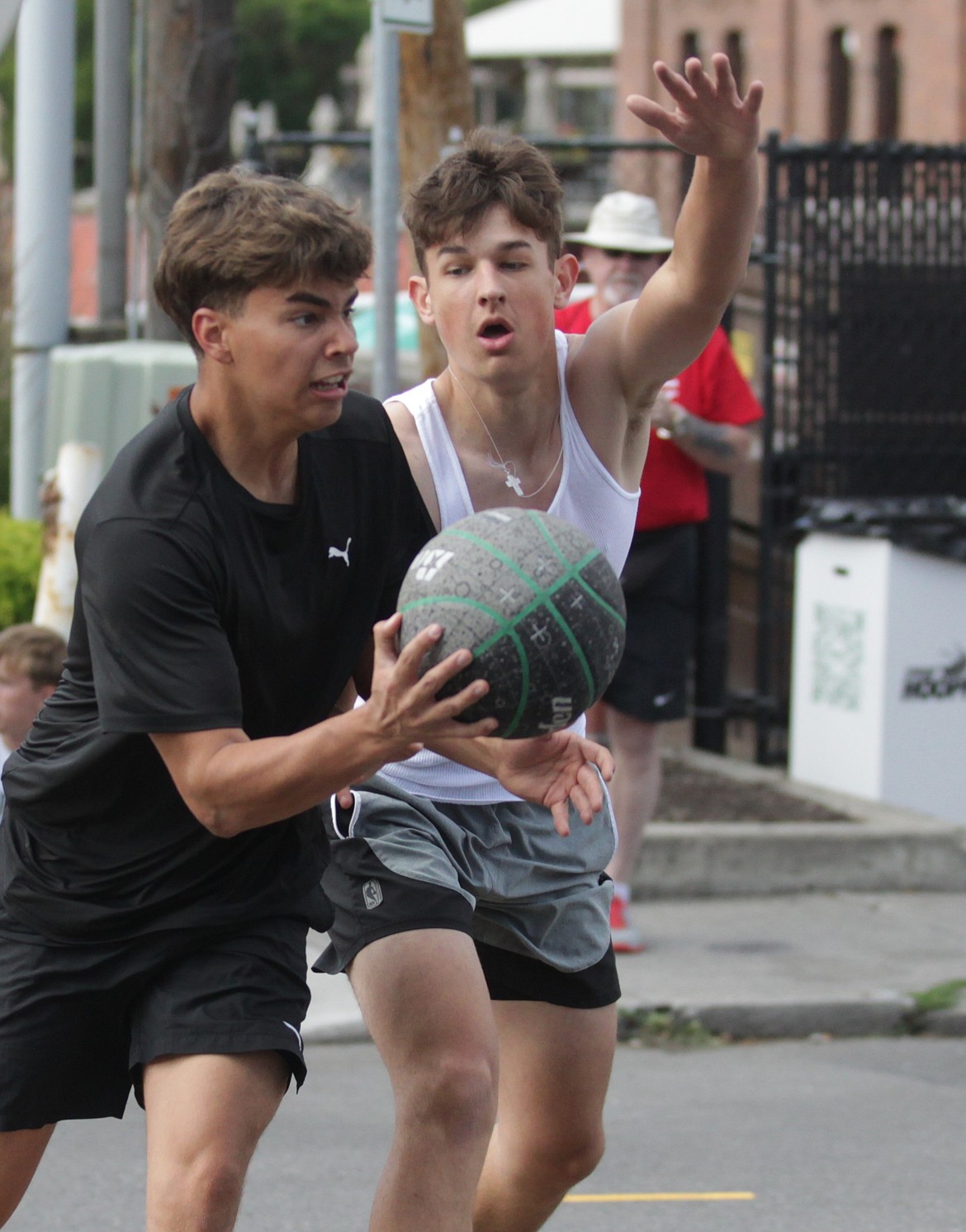 JASON ELLIOTT/Press
Isaiah Naylor of Friends, a group of recent Post Falls High boys basketball players, looks to pass during the team's opening game against Slavic Slums at the 37th annual Hoopfest 3-on-3 basketball tournament in Spokane.
