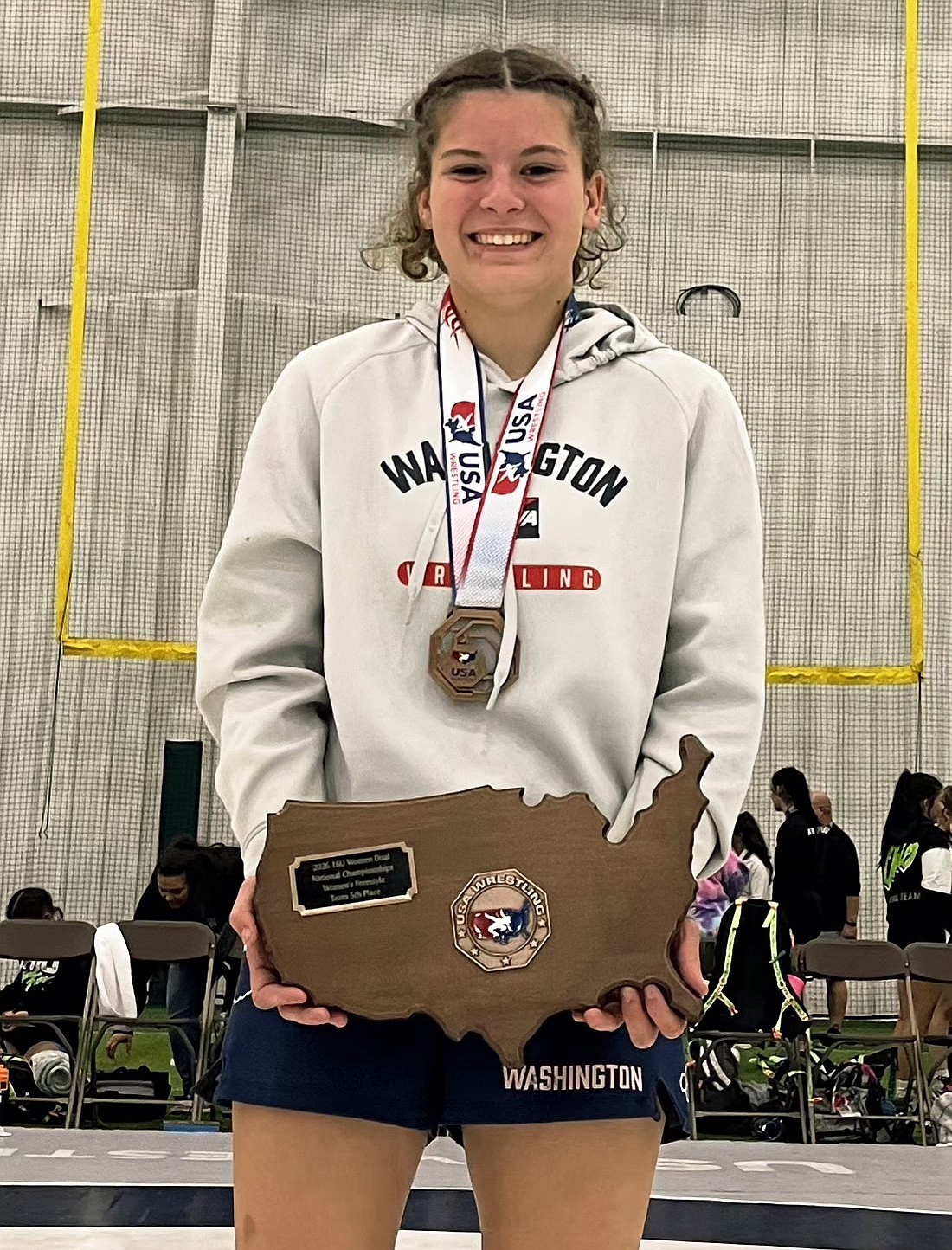 Karis Butler holds a trophy she earned at the Women’s National Duals, where she competed in freestyle and Greco-Roman wrestling.