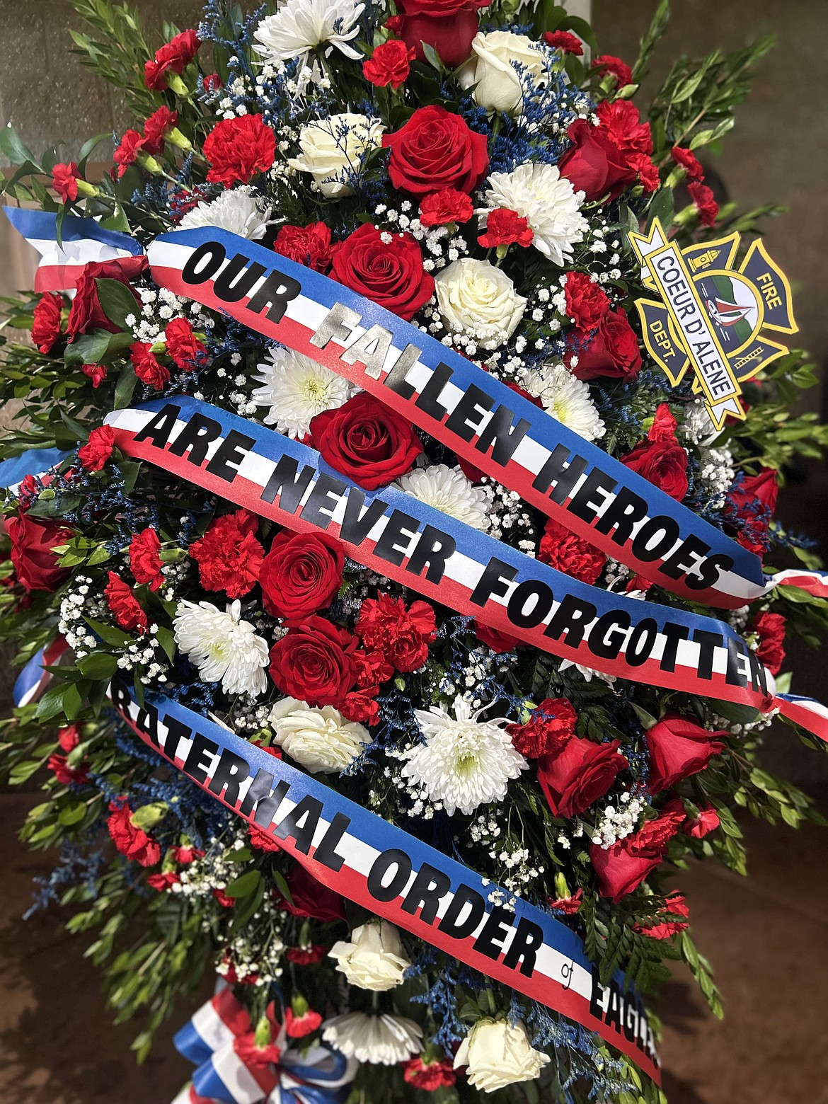 Flowers are displayed at Avista Pavilion during Monday's remembrance ceremony for John Morrison and Frank Harwood.