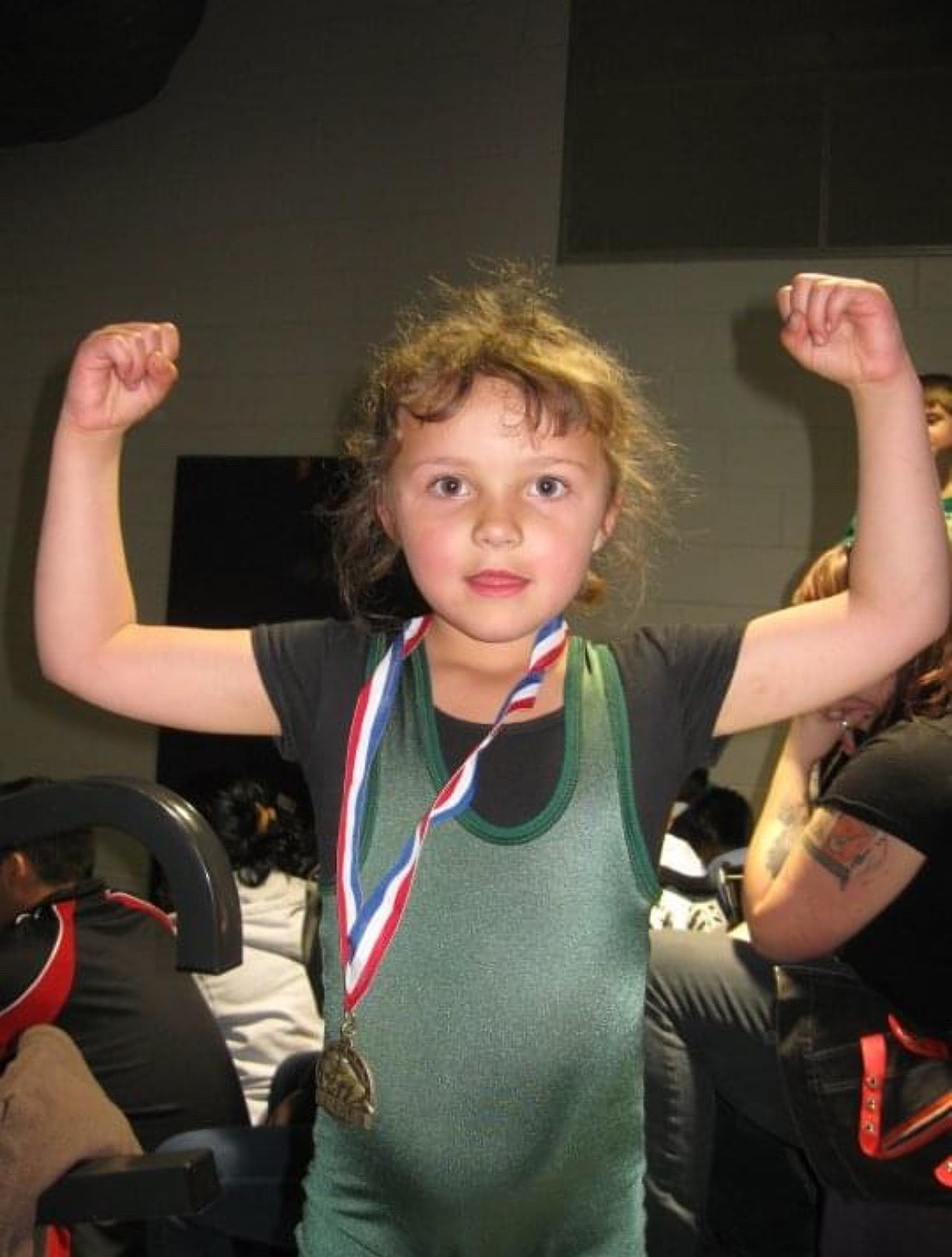 A young Shannon ‘Duckie’ Workinger flexes after winning a wrestling medal. Originally from Quincy, she returns to the Basin as the Lady Vikings newest wrestling head coach.