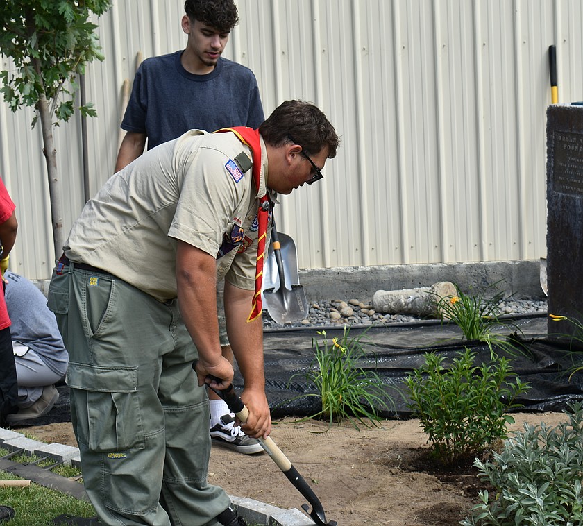 Boy Scout Carson Overfield plies his shovel at the memorial garden he put in at the Grant County Fairgrounds Tuesday. The garden was the project he selected as the last step to becoming an Eagle Scout, the highest rank in Scouting.