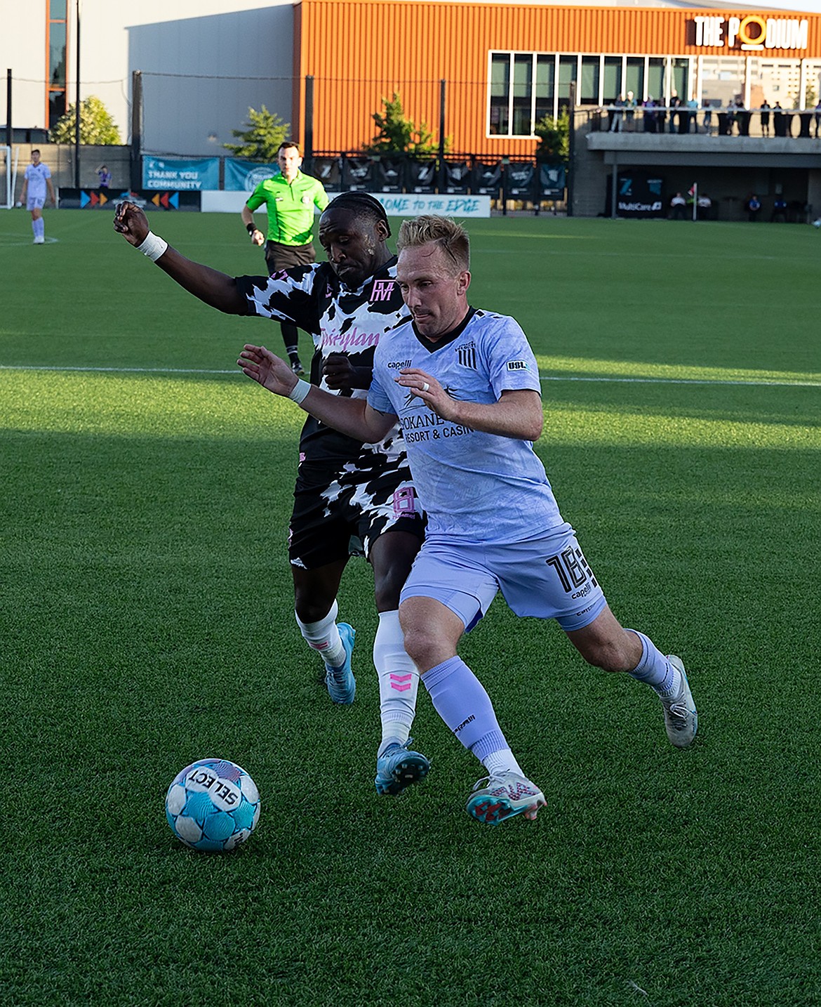 Photo by JERRY VICK
Derek Waldeck (18) of the Spokane Velocity cuts toward the goal as Mark Segbers of Forward Madison FC defends on Wednesday at ONE Spokane Stadium. On the day the U.S. Men's National team advanced to the Round of 16 at the FIFA World Cup, the Spokane Velocity entertained the crowd at ONE Spokane Stadium, falling 1-0 to Forward Madison FC on an own goal.