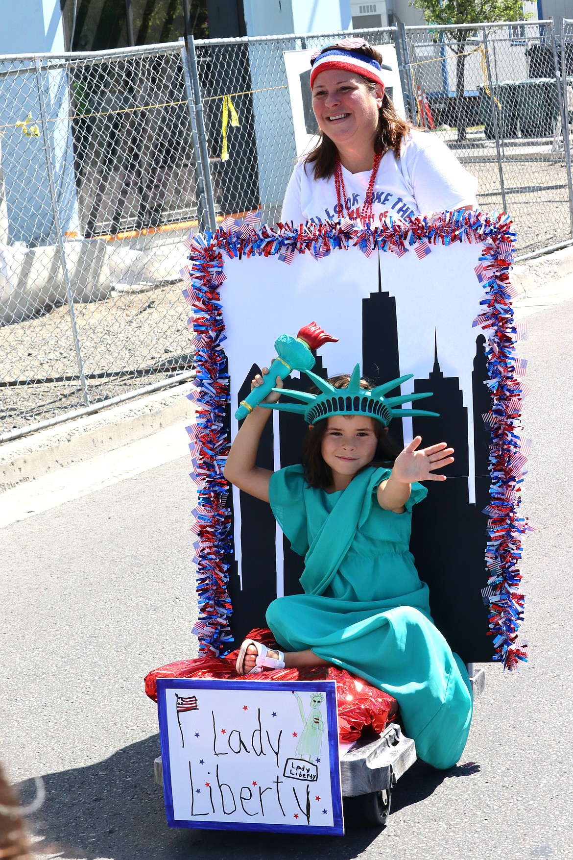 Lilly Aguirre gets help from mom Katie Aguirre going through the Kiddie Parade.