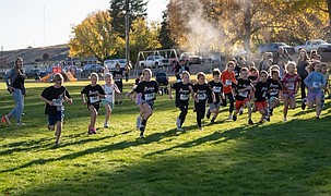 A group of young athletes sprint across the field during a previous Running Club meet. The club is looking to hire a new volunteer instructor for the fall.