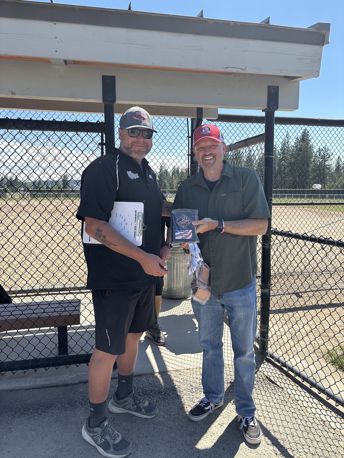 Rage Head Coach Bob Richardson (left) receives a plaque for the team taking third place in the Fourth of July Shootout tourney.