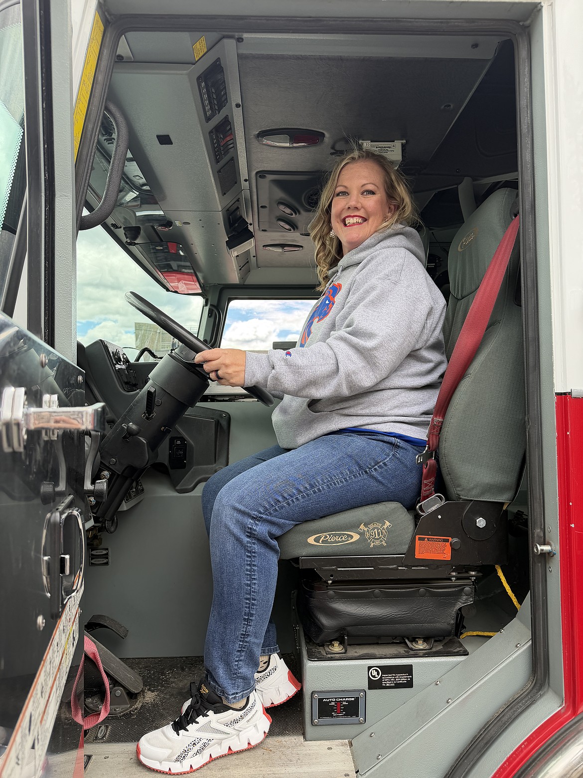 Megan Hexum takes a seat behind the wheels of a Kootenai County Fire and Rescue Truck during a River City Leadership Academy event.