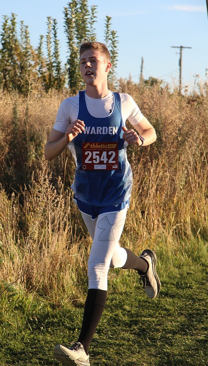 Warden Cougars athlete Soren Clausen runs along the path during the last cross-country season.