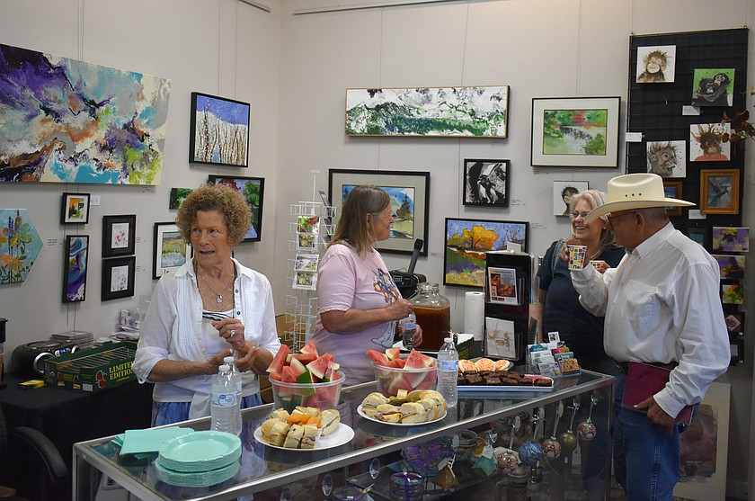 From left: Up Town Art Gallery owners Judy Kalin and Leanne Hickman visit with Maxine Smith and her husband, cowboy poet Paul Smith, at the opening of the gallery’s equine-themed exhibition, “Year of the Horse,” Friday.