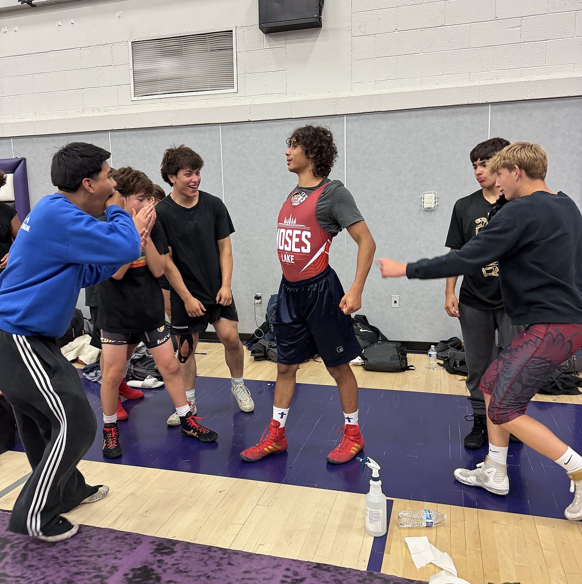 Duane Zamora stands proud at the center of all his teammates while the group jokes around at the Redneck Duals.